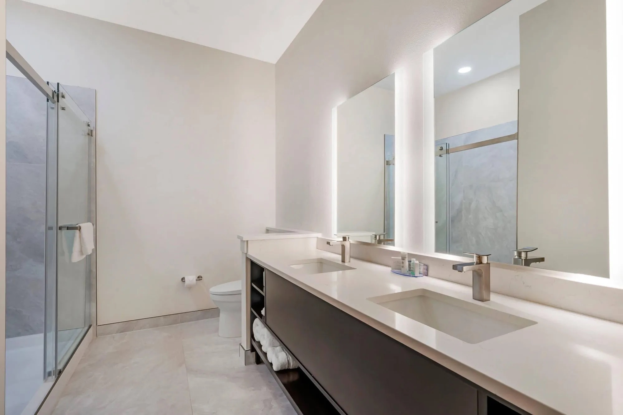Double vanity bathroom with glass shower